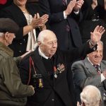 Holocaust survivor Joshua Kaufman left applauds World War II D Day Veteran Herman Zeitchik joined by fellow D Day veterans Irving Locker Official White