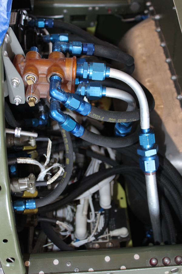 Hoses and wiring behind the pilot's instrument panel. (photo via Tom Reilly) 