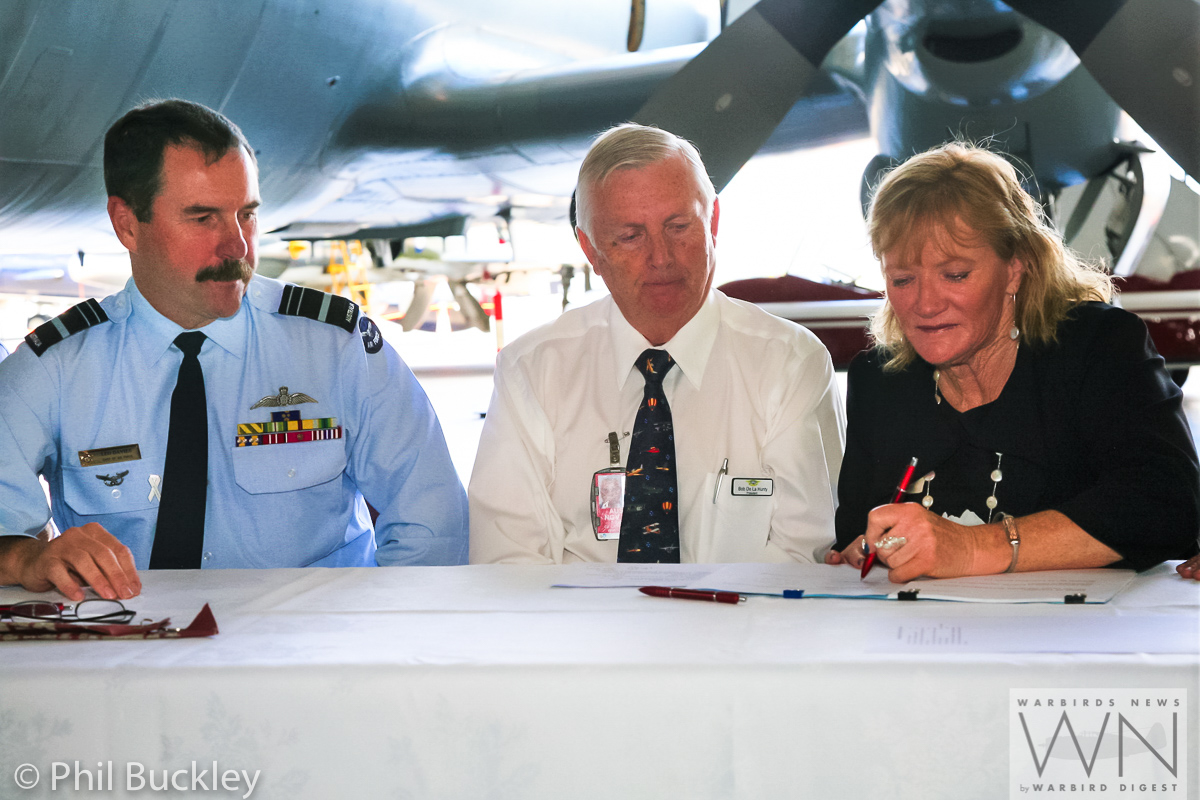 Signing the handover documents. (photo by Phil Buckley)