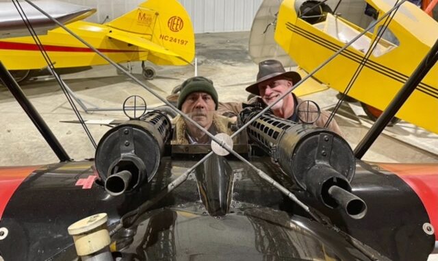 Iron Maiden's Bruce Dickinson in the Old Rhinebeck Fokker Dr.I replica compares notes with ORA pilot Dave King. [Photo via Old Rhinebeck Aerodrome]