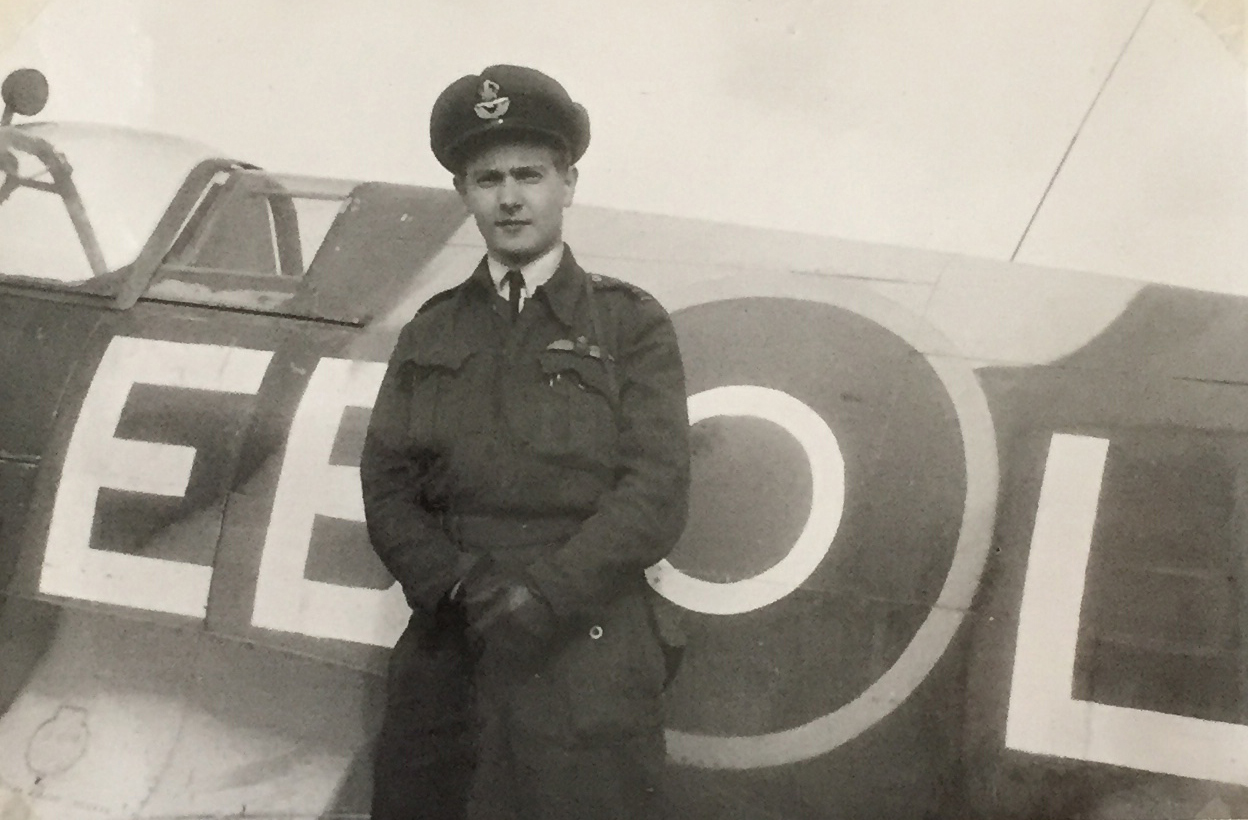 F/L John Wilkinson stands next to his Spitfire Mk.14 circa 1945, Belgium