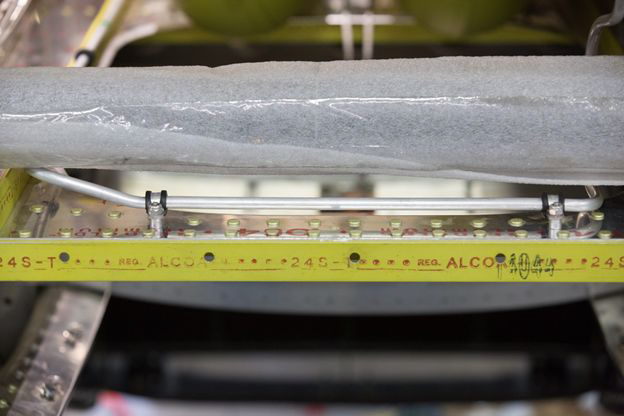 An oxygen line clamped down to one of the structural elements in the rear fuselage. Note the perfectly replicated Alcoa labeling and the inspection stamp. (photo via AirCorps Aviation)