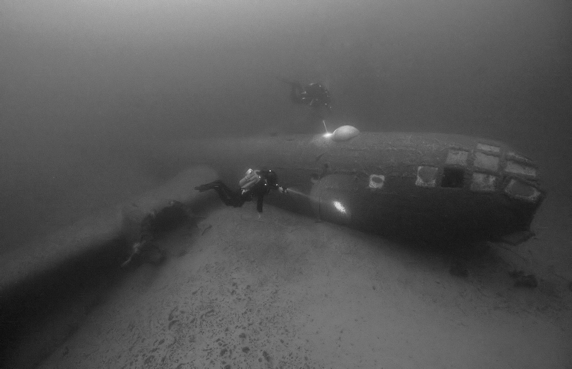 Divers inspect the wreck of the B-29 ( Image provided by Gregg Mikolasek - Director Undersea Voyager Project