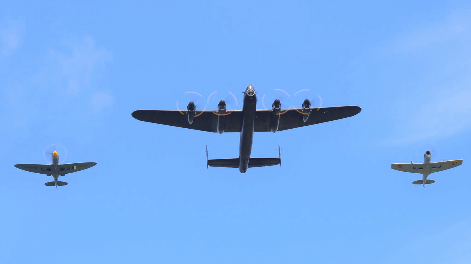 Lancaster PA474 and Spitfires TE311 and PM631 arrive over the crowd on Members Day 2025. Photo Keith Chadwick