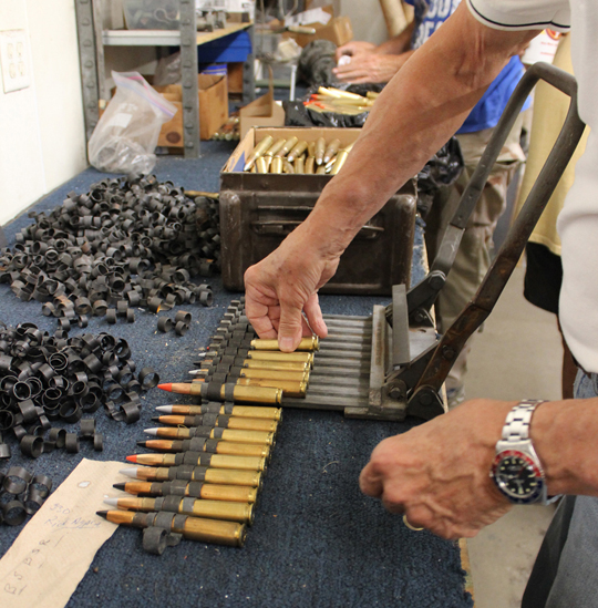 Loading the .50 caliber cartridges into the linker. (photo via Tom Reilly)