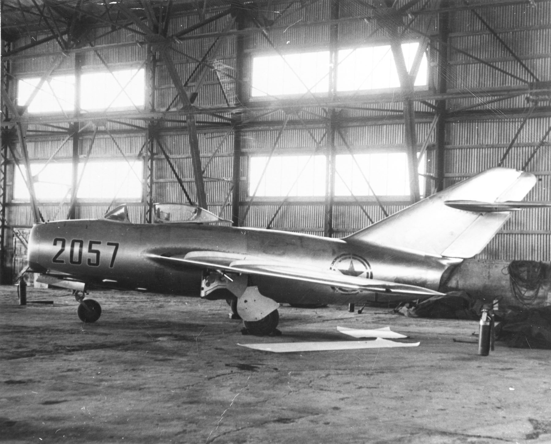 MIG 15 Red 2057. A North Korean Peoples Air Force Mikoyan Gurevich MiG 15bis in a hangar at Kimpo Air Base Republic of South Korea