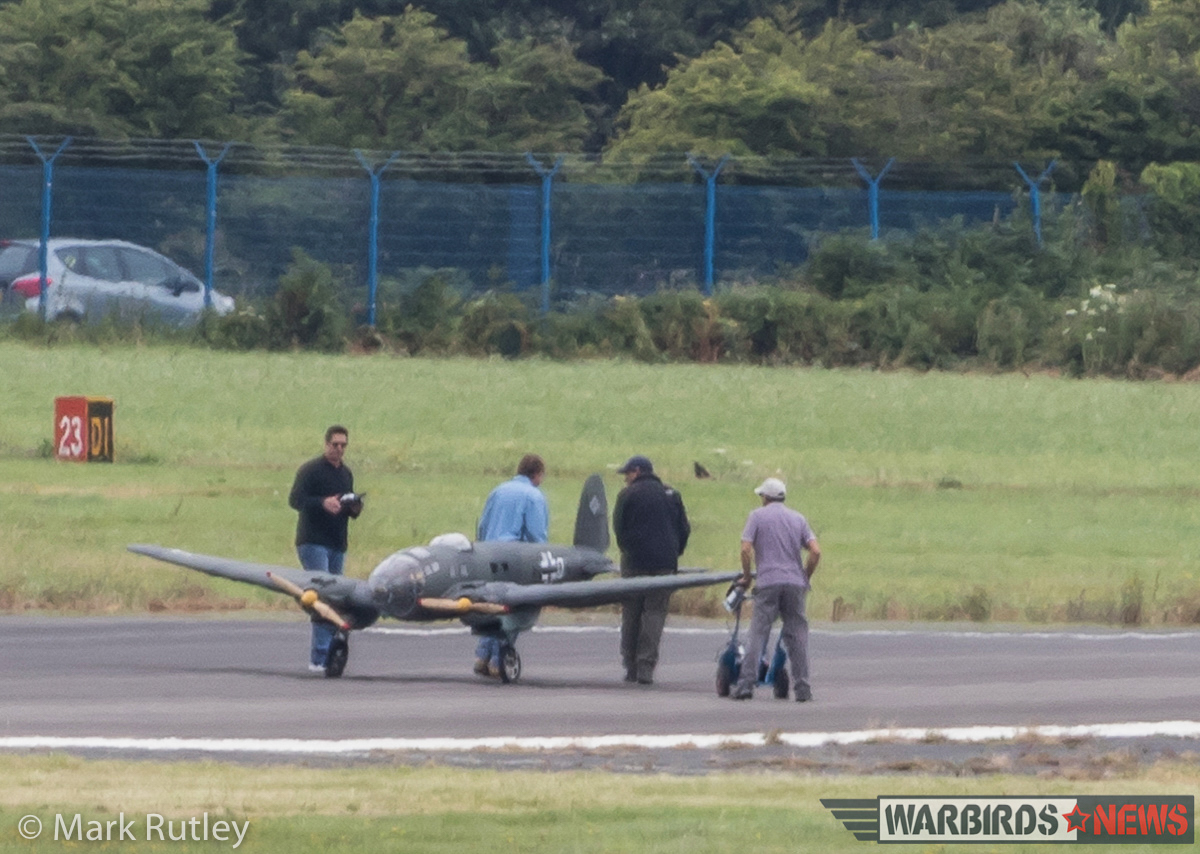 The film crew seen preparing one of the large-scale, remotely controlled He 111 bombers for flight. (photo by Mark Rutley)