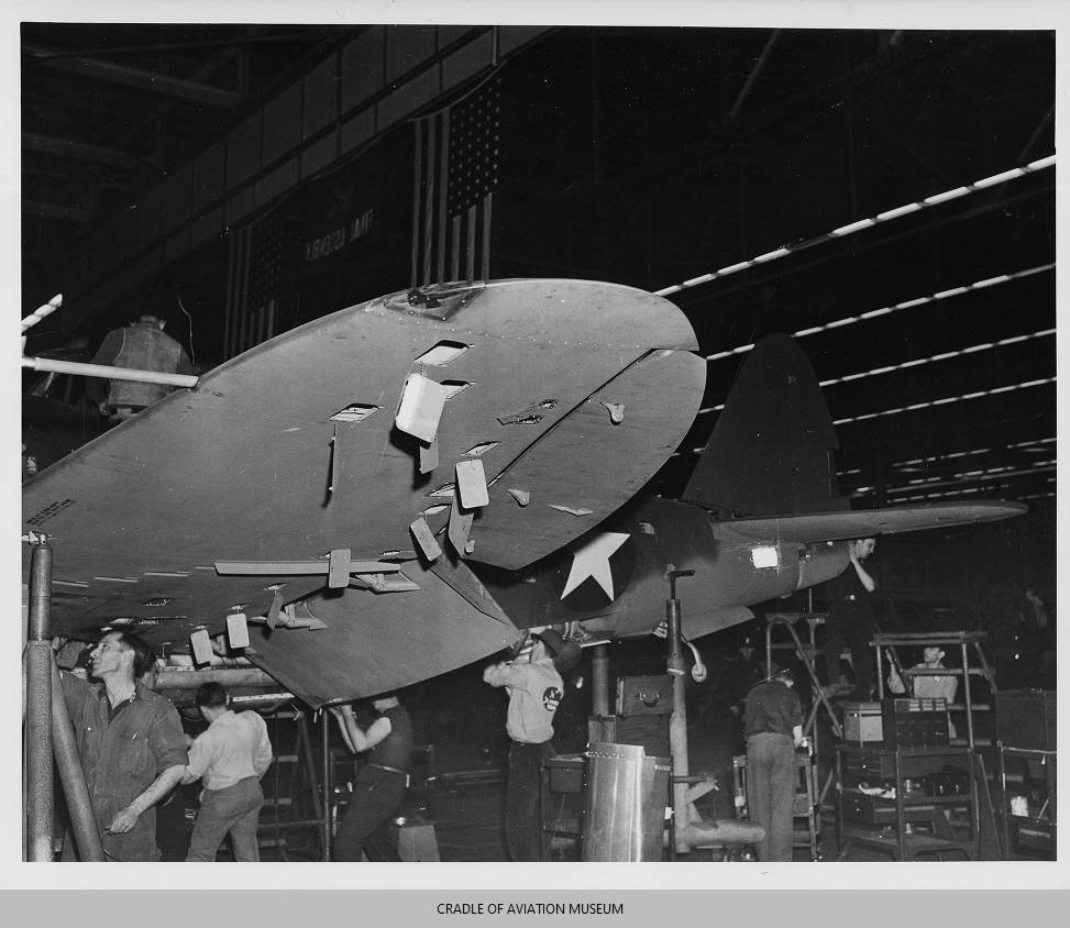 Inside the Engineering of the Republic P-47 Thunderbolt 18 Male workers working on the left wing of a P 47