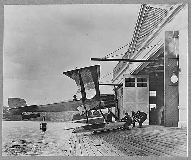 Today In Aviation History: First Flight of the Boeing Model 1 12 Men pulling B W into Boeing Seaplane Hangar on Lake Union Seattle 1916 MOHAI 1818
