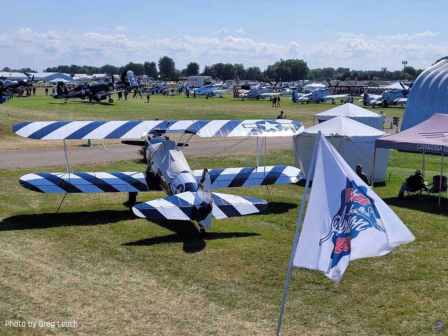 Tom Torchia's Stearman parked across the Fighter Alley lawn at AirVenture 2024. Photo by Greg Leach