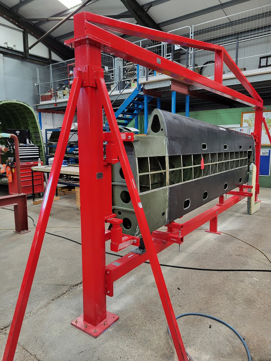 NX611s port and starboard tail planes mounted into the jigs ready for their restoration to begin