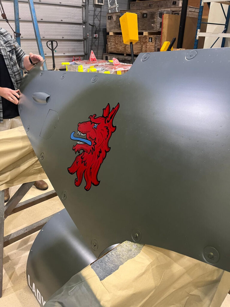 One of the last tasks before MJ444s first post restoration flight was to add the 403 Squadron wolf nose art to the port engine cowling Photo Martin Overall