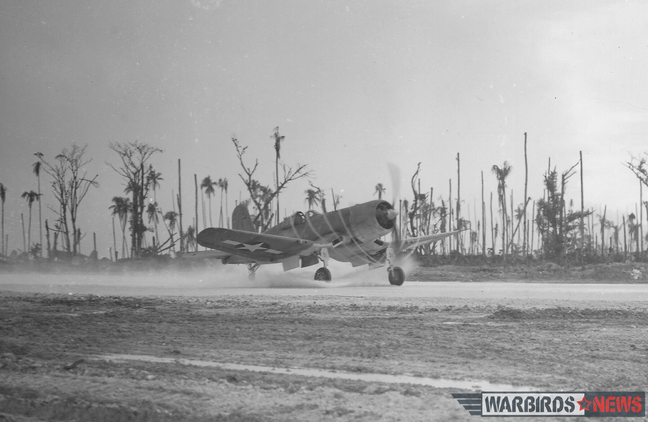 Frequent tropical downpours and crude airstrips—some were bare crushed coral, others had an interlocking mat of pierced steel planking—presented aviators in the Solomons with plenty of challenges. The F4U’s sturdy construction and wide stance gave it stability, but that long nose blocked forward visibility, making takeoffs or landings especially hazardous in poor weather. Here, the propeller of an F4U-1 of VMF-215 leaves a vapor trail as it accelerates down the strip at Munda Point, New Georgia. Photo credit: Bruce Gamble collection via National Archives