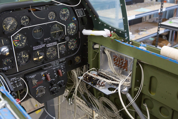 The view of the right hand side of the cockpit shows the circuit breaker box opened up. (photo via AirCorps Aviation)