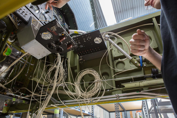 The complex wiring looms going into the cockpit, as seen from below the fuselage. (photo via AirCorps Aviation)