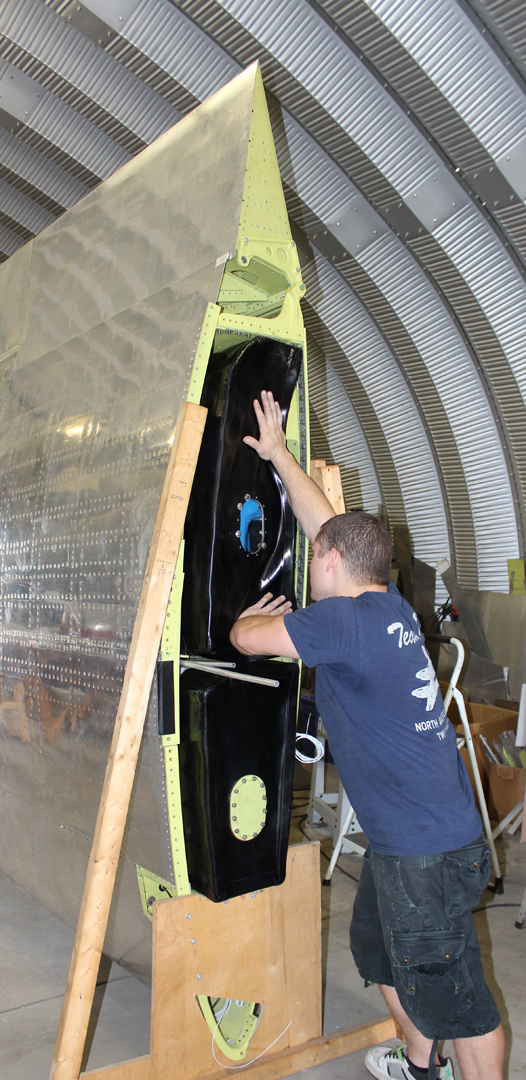 Installing the right hand wing fuel tanks (205 gallons total). (photo via Tom Reilly)