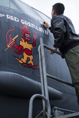 U.S. Air Force Capt. Kerry Baker applies nose art on a 93rd Bomb Squadron B-52H Stratofortress, Nov. 15, 2013, Barksdale Air Force Base, La. The original "Red Gremlin" nose art was on a World War II B-17 bomber piloted by Brig. Gen. Paul Tibbets, Jr. (U.S. Air Force photo by Master Sgt. Greg Steele/Released)