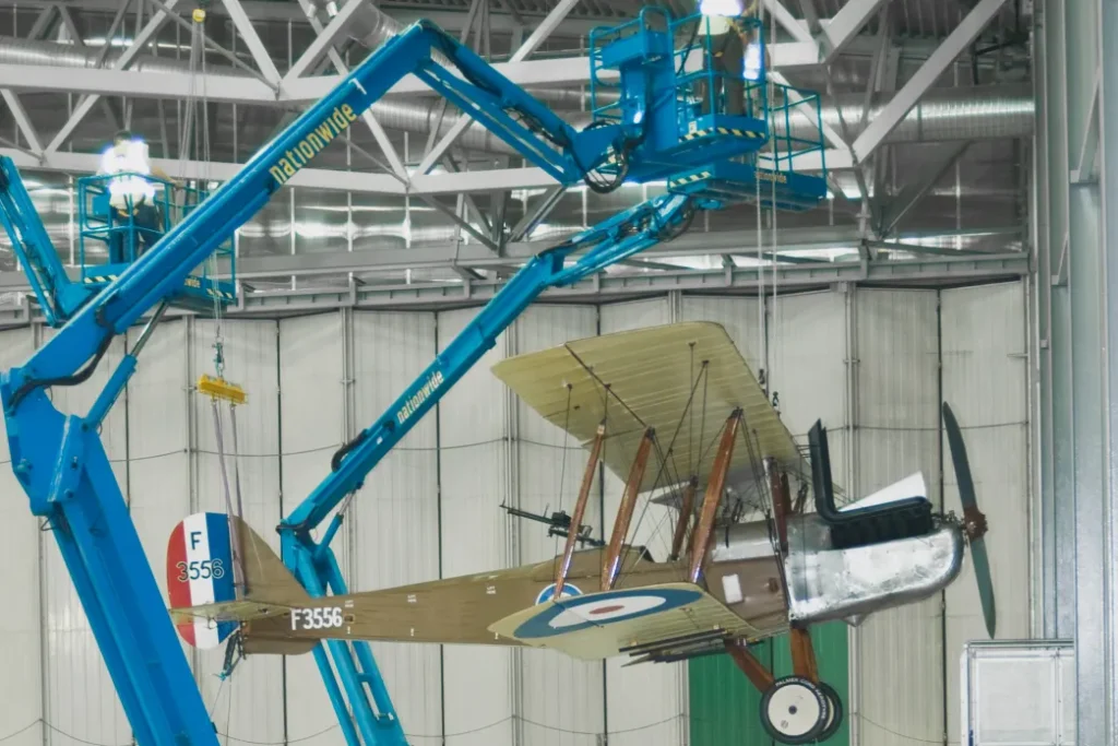 Royal Aircraft Factory R.E.8 being raised to the roof of AirSpace at IWM Duxford © IWM