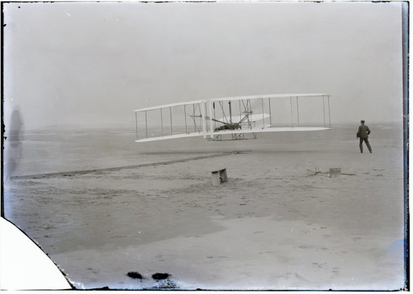 Orville takes off with Wilbur running beside, December 17, 1903. ( Original Image)