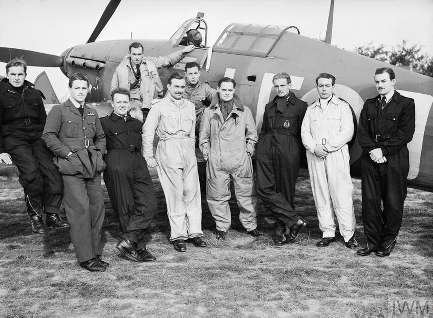 Squadron Leader Douglas Bader DSO front centre with some of the Canadian pilots of his Squadron 242 Canadian Squadron grouped around his Hurricane fighter aircraft at Duxford. © IWM CH 1413 © IWM CH 1413