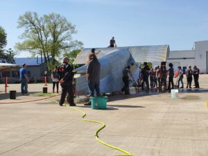 Students from EHOVE Adult Career Center and museum volunteers wash the fuselage of NC9684 before it is painted May 2023 THF s Port Clinton Ford Tri Motor Restoration