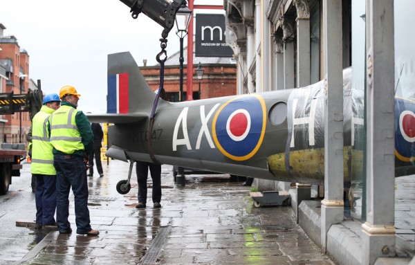 Technicians gently ease the fuselage of Spitfire FR.XIVe MT847 out of the Museum of Science and Industry in Manchester, England on February 9th. (photo by Chris Foster, via RAF Museum)