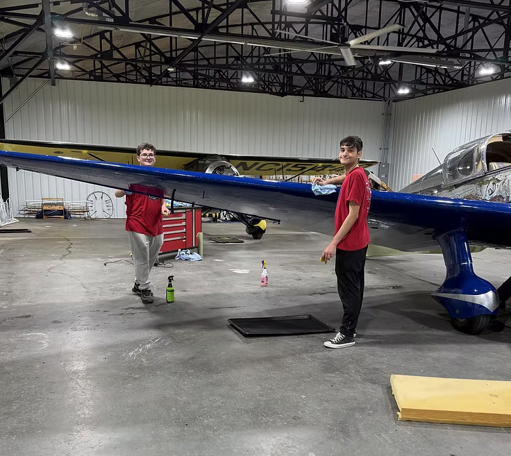 Three Good Reasons to Restore an Antique Aircraft 14 TCC Volunteers polishing the 1938 Ryan SCW