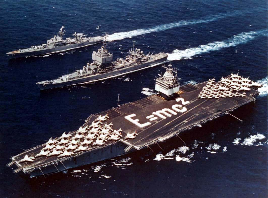 Task Force 1, the world's first nuclear-powered task force. Enterprise, Long Beach and Bainbridge in formation in the Mediterranean, 18 June 1964. Enterprise has Einstein's mass–energy equivalence formula E=mc² spelled out on its flight deck. Note the distinctive phased array radars in the superstructures of Enterprise and Long Beach.