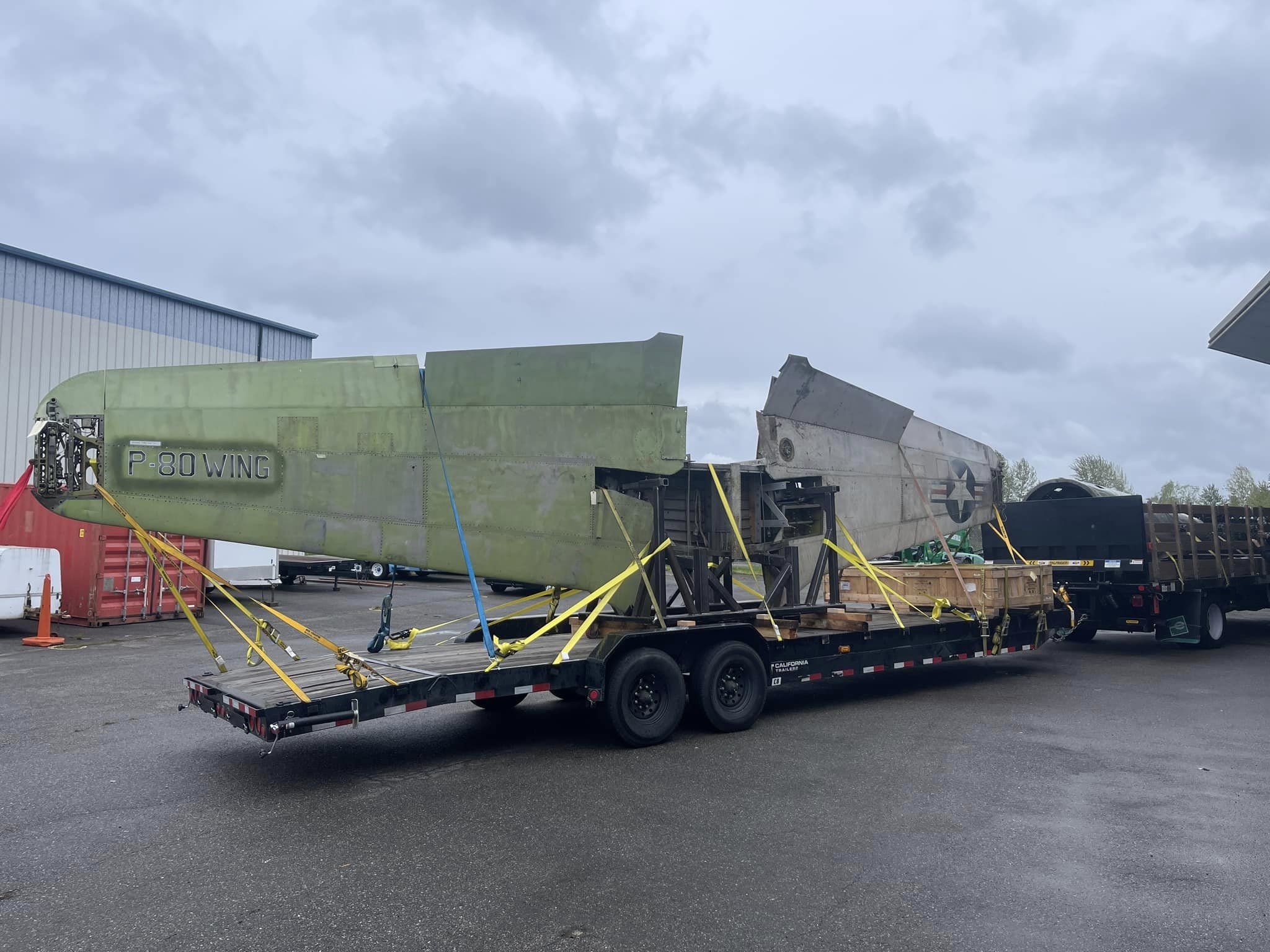 The Shooting Stars wings are placed on a trailer while the tail is in the bed of the truck towing the wheels down to Riverside Greg Stathatos B 17 Archaeology