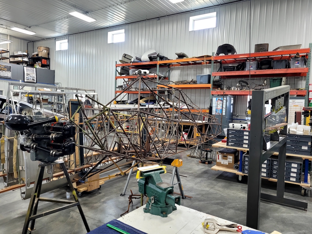 The fuselage frame and engine at the AirCorps Aviation hangar