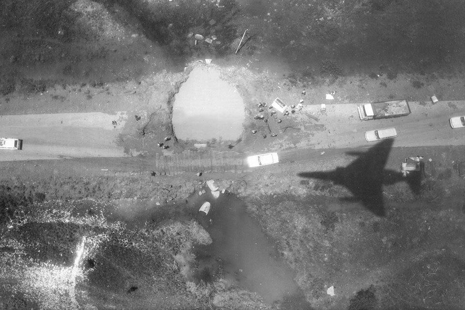 The shadow from a RF 4C is visible in a bomb damage assessment image h