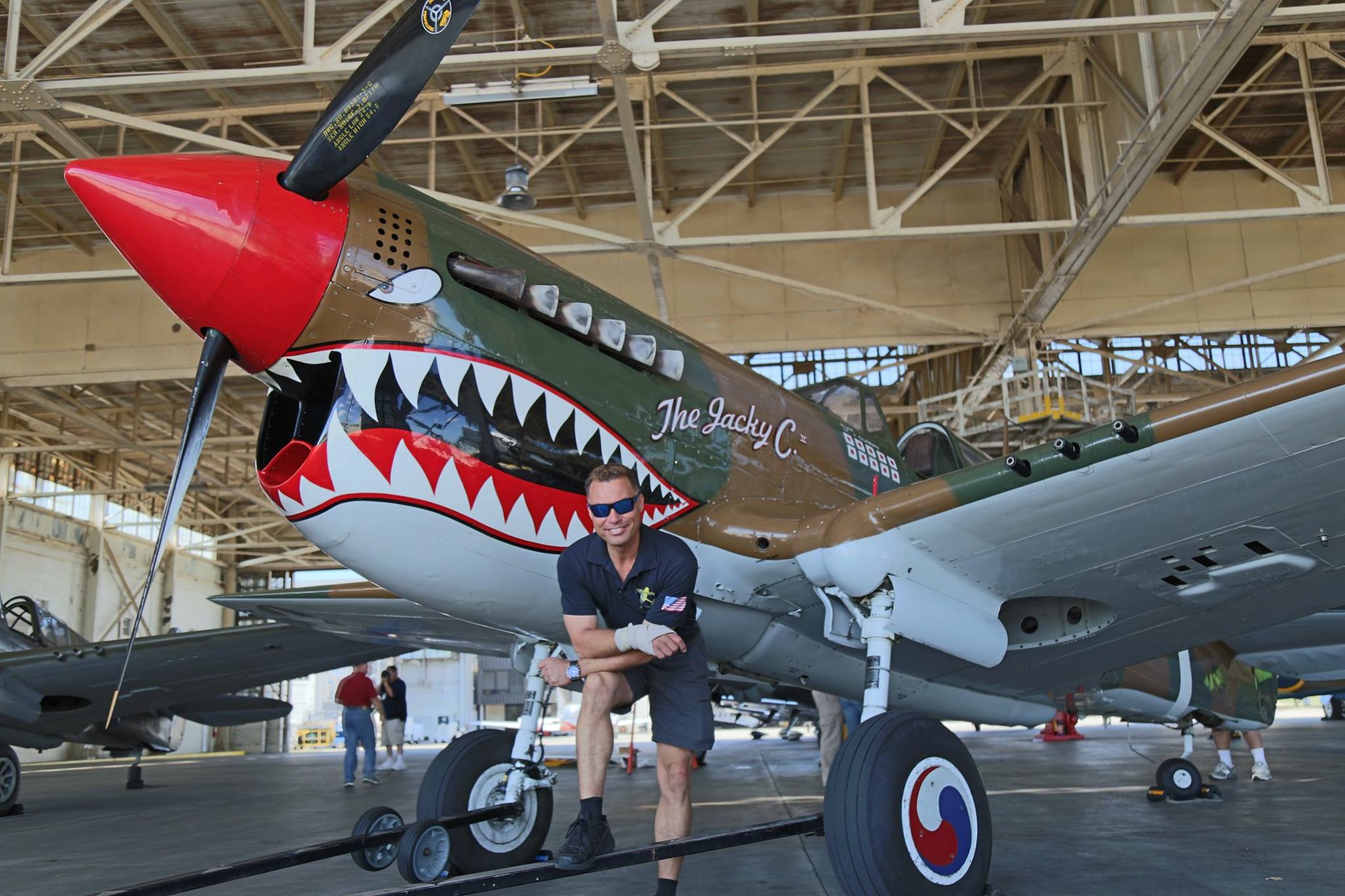 Thom Richard in front of the American Airpower Museum's P-40 in occasion of the 2016 Atlanta Warbird Weekend. (Photo by Kenneth Strohm)