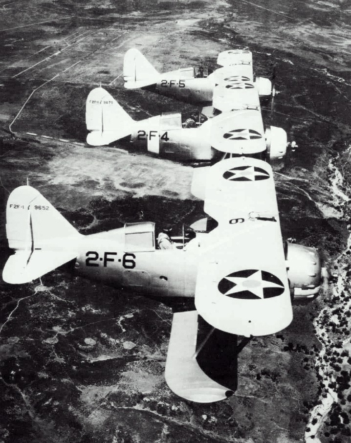 Three Grumman F2F 1 fighters of U.S. Navy fighter squadron VF 2 assigned to the aircraft carrier USS Lexington CV 2 in flight in the 1930s