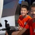 Two ACE campers enjoy a flight simulator at the Museum during their camp experience. Sean Mobley The Museum of Flight