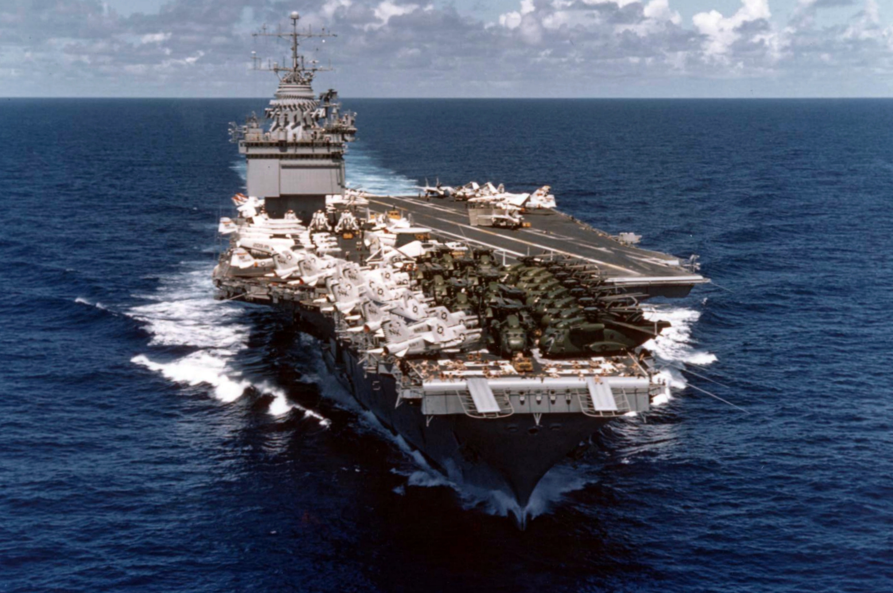 Enterprise en route back to the United States following the evacuation of Saigon; the forward end of the flight deck contains a number of USMC CH-53 Sea Stallion helicopters.