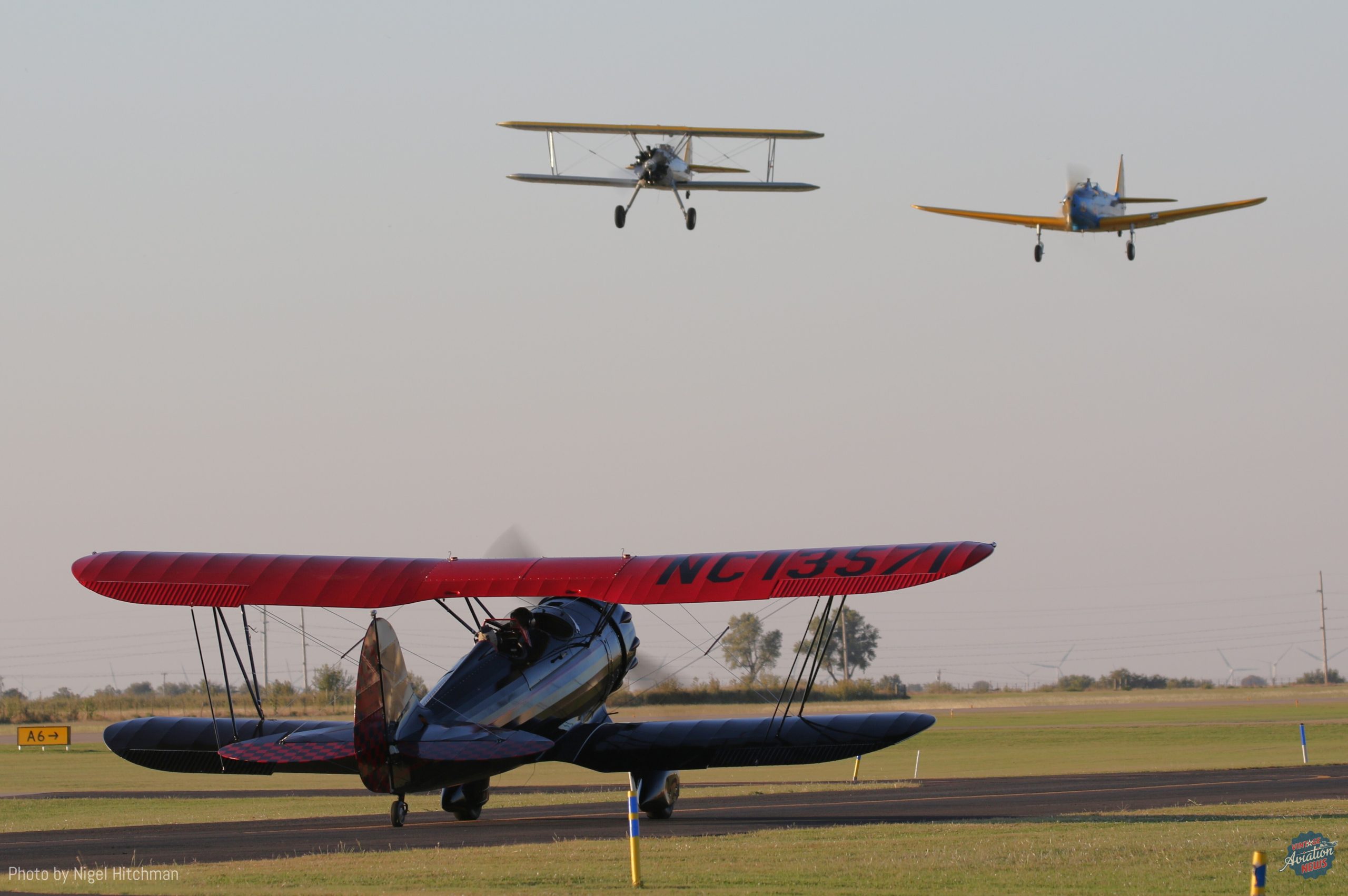 Waco UMF 3 taxis out as Fairchild PT 19 and Stearman fly overhead scaled