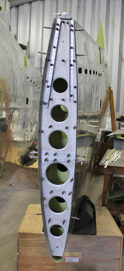 Finishing up the riveting on the final outboard wing bulkhead. The wing tip attaches at this station. (photo via Tom Reilly)