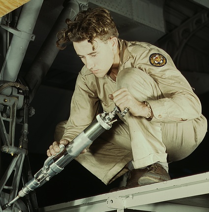 Consolidated Aircraft Corporation – The Celebrated Manufacturer of the B-24 Liberator 11 a hydraulic mechanic greasing the landing gear of a transport1a34930v cropped