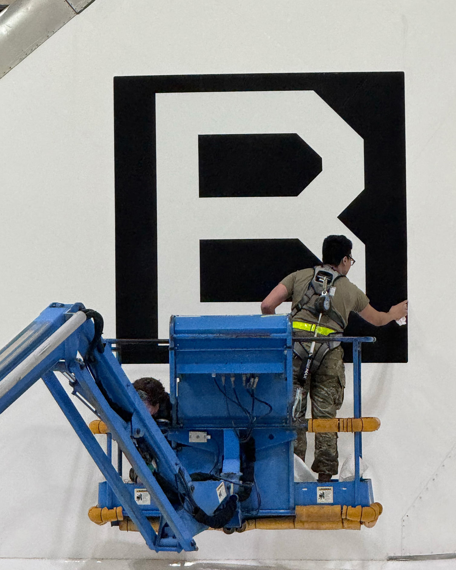 95th Wing Revives Historic WWII 'Square B' Tail Marking on E-4B Nightwatch 13 a team comprised of airmen and civilians assigned to the 95th maintenance group apply an edge sealant to a square b vinyl applique on the tail of an e 4b nightwatch at offutt air force base