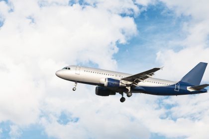 airplane flying cloudy sky