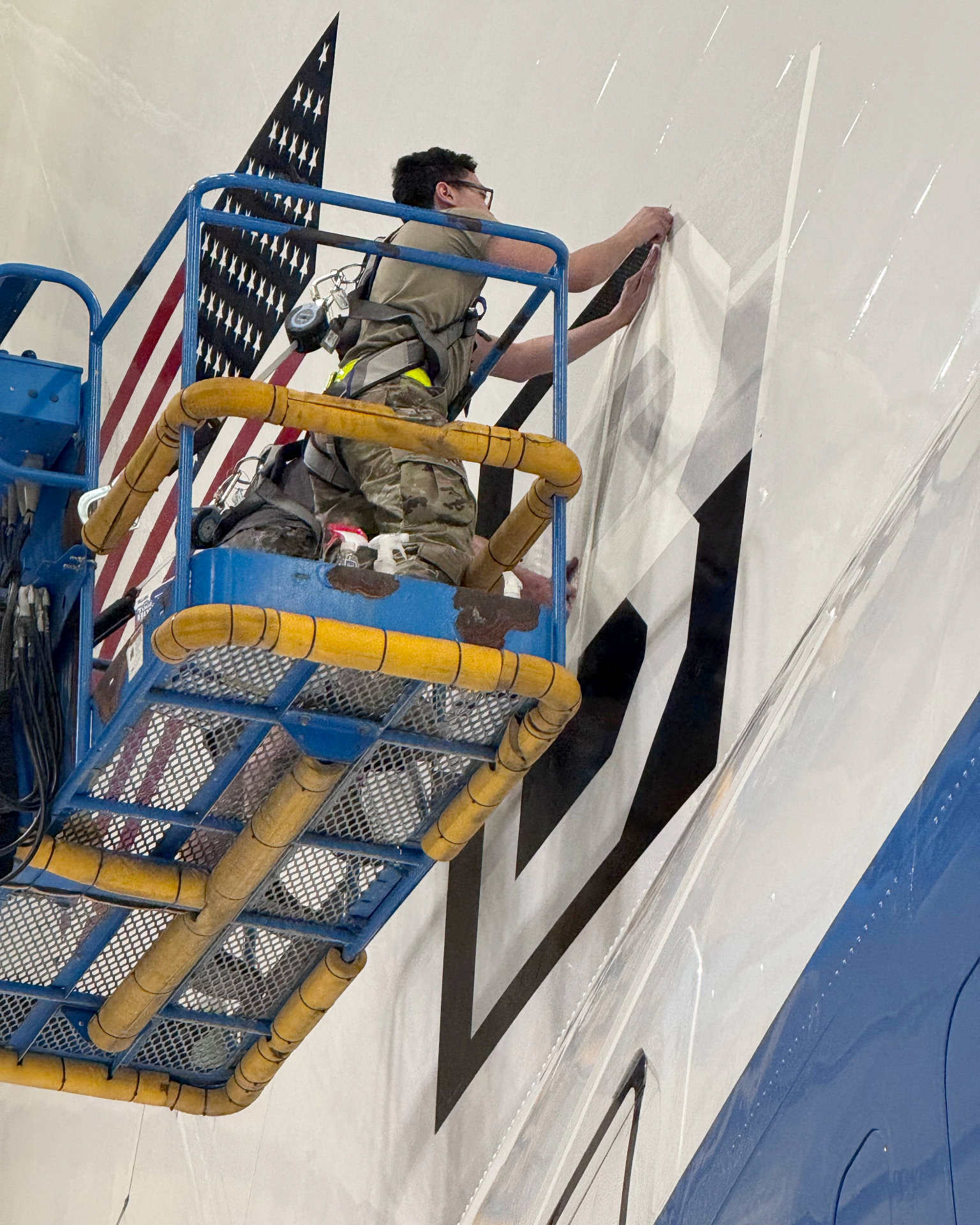 95th Wing Revives Historic WWII 'Square B' Tail Marking on E-4B Nightwatch 12 an airman assigned to the 95th maintenance group removes tape from a square b vinyl applique on the tail of an e 4b nightwatch at offutt air force base