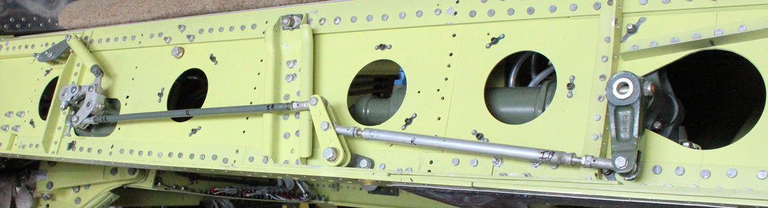 The center section main spar with the exposed gear up-lock mechanisms. (photo via Tom Reilly)