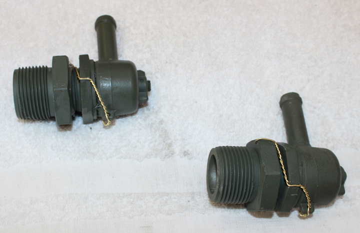 A pair of airworthy coolant tank pressure relief valves. (photo via Tom Reilly)