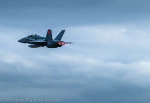 A CF-118 Hornet blasts off into the darkening clouds in Gatineau, Quebe