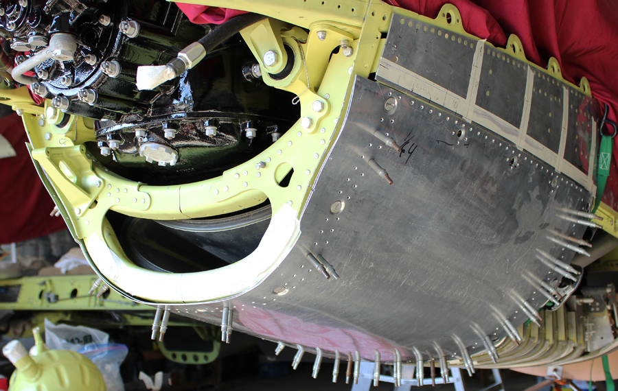 The lower cowling for the left hand fuselage being trial fitted. (photo via Tom Reilly)