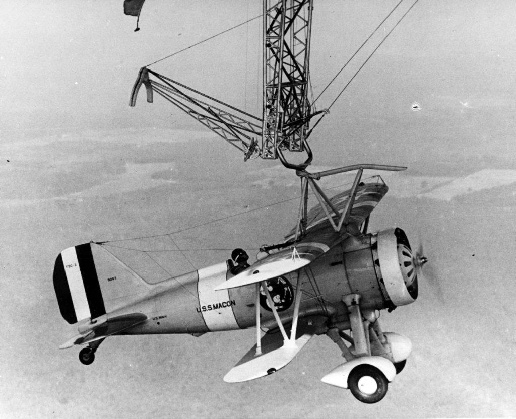 Travel For Aircraft Bookshelf - Skyhookers: An Illustrated History of Hook-On Aircraft and Their Dirigible Motherships by William Wolf 13 lt. harrigan piloting an f9c sparrowhawk hamngs from the trapeze of the uss macon zrs 5 credit nhhc 80 g 441979