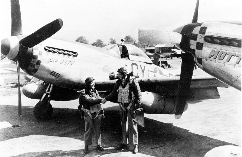  Lt. Richard “Dick” Jacobson (L) and Capt. Edward Unger (R) both ex 486th Bomb Group, congratulate each other on being assigned to the 3rd Scouting Force. Unger was the pilot of the B-17 "Five Grand" (the 5,000th B-17 produced by Boeing) and Jacobson the co-pilot. They both finished their tours with the 486th at the same time and both volunteered for the Scouting Force. Due to the disparity in their heights, with Ed being 6' 4" and Dick 5' 6", they were known as "Mutt and Jeff" from the popular cartoon characters of the time and named their P-51s accordingly. Photo via NARA
