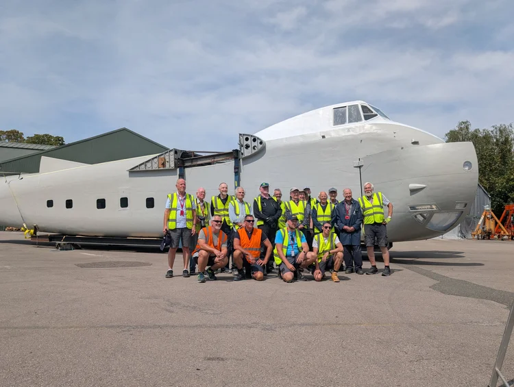 Aerospace Bristol Reattaches Centre Wing to Rare Bristol Freighter 16 the conservation team wearing hi vis with the bristol freighter outside