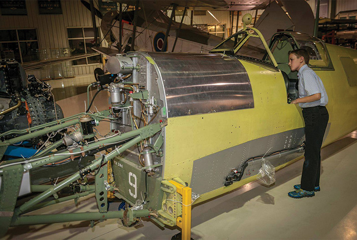 In September of 2014, the fuselage of the Roseland Spitire arrived at Vintage Wings of Canada, having been delivered from the Vintech Aero team at Comox, British Columbia's Air Force Museum. It was unveiled at a special dinner where, Roseland's great grandson Aidan had a first hand look at the cockpit. Today, Aidan is now Corporal Roseland-Barnes of the Royal Canadian Air Cadets. (Photo b y Peter Handley)