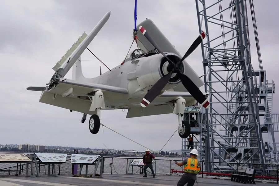 USS Midway Museum Welcomes Back Its Restored Douglas A-1 Skyraider 12 uss midway museums douglas a 1 skyraider buno 127922 crane